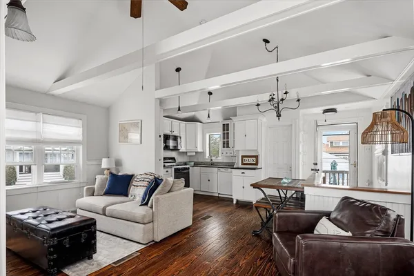 a kitchen with kitchen island white cabinets and white appliances