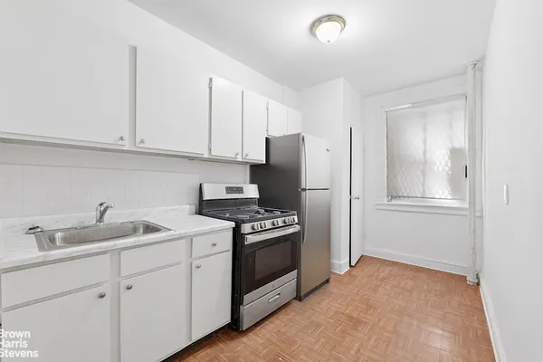 a kitchen with a sink stove and refrigerator