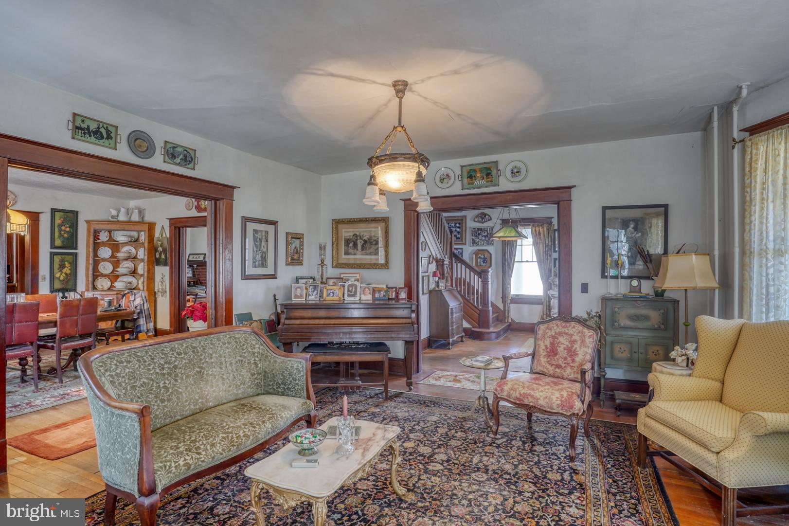 4096 Main Street Trappe, MD 21673 - Photo 21 of 70 a living room with furniture a rug and a chandelier