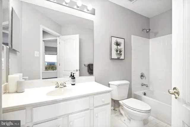 a bathroom with a sink toilet and a mirror