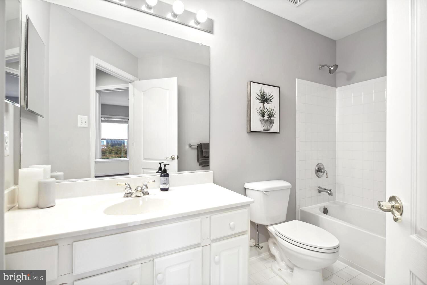 10258 Rutland Round Road, Unit 13 Columbia, MD 21044 - Photo 17 of 24 a bathroom with a sink toilet and a mirror