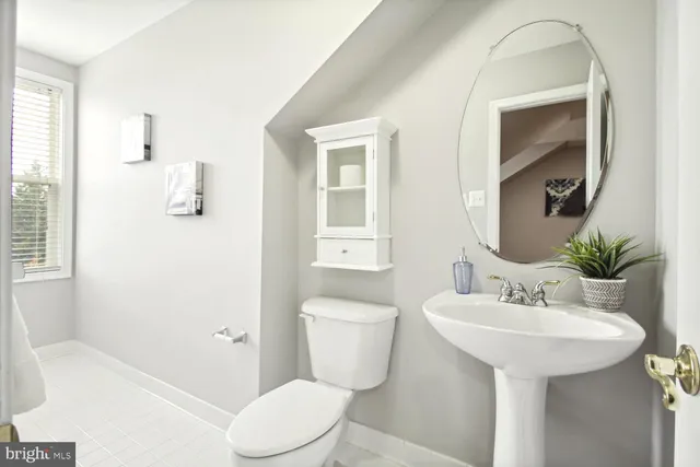 a bathroom with a sink toilet and mirror