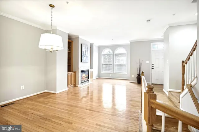 a an empty room with wooden floor and a window