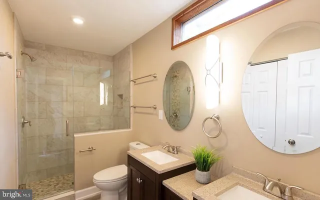 a bathroom with a sink mirror and toilet