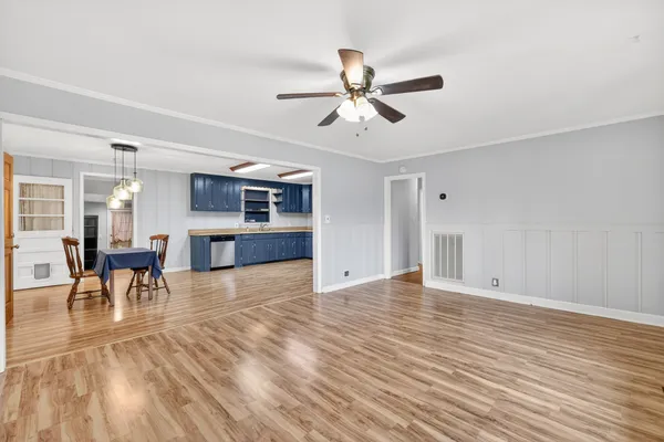 a view of empty room with wooden floor and window