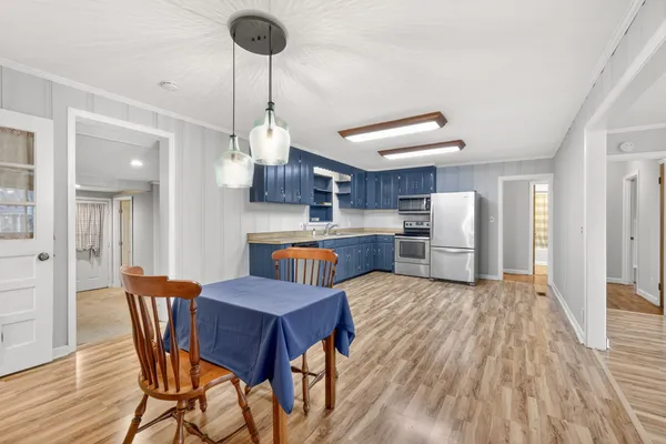 a view of kitchen and dining room with wooden floor