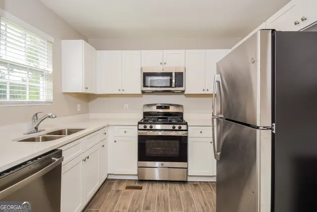 a kitchen with a refrigerator stove and sink