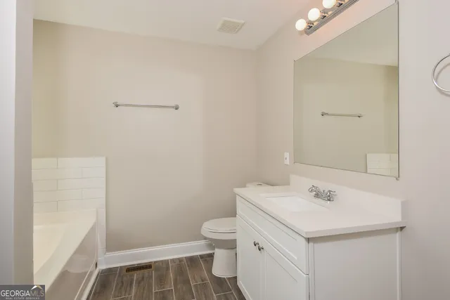 a bathroom with a sink toilet and tub