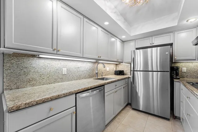 a kitchen with a sink stainless steel appliances and cabinets