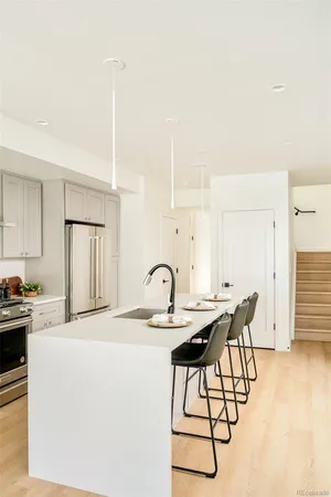 a kitchen with granite countertop a table chairs stove and cabinets