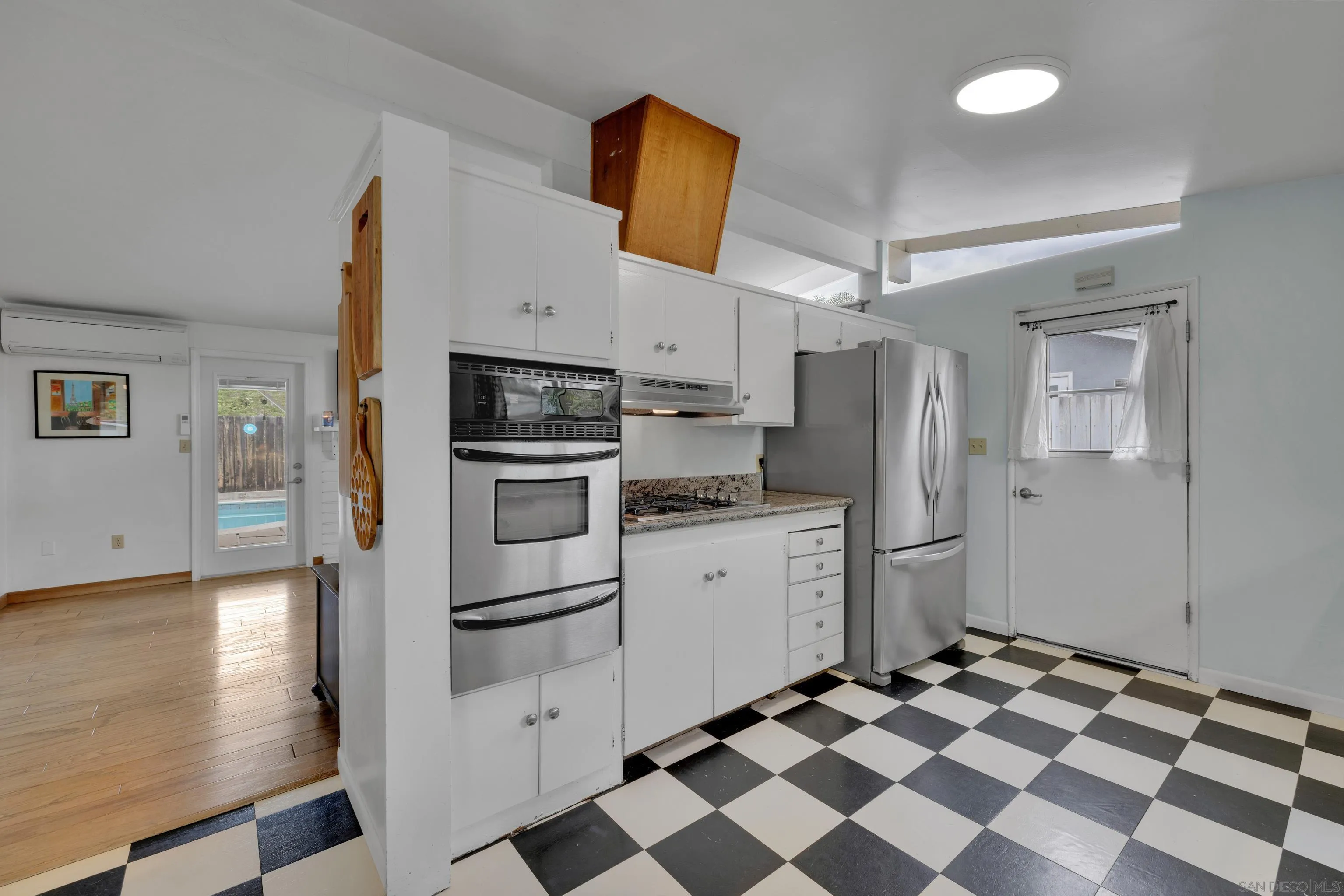 13834 Tobiasson Road Poway, CA 92064 - Photo 13 of 31 a kitchen with stainless steel appliances a refrigerator and a stove top oven