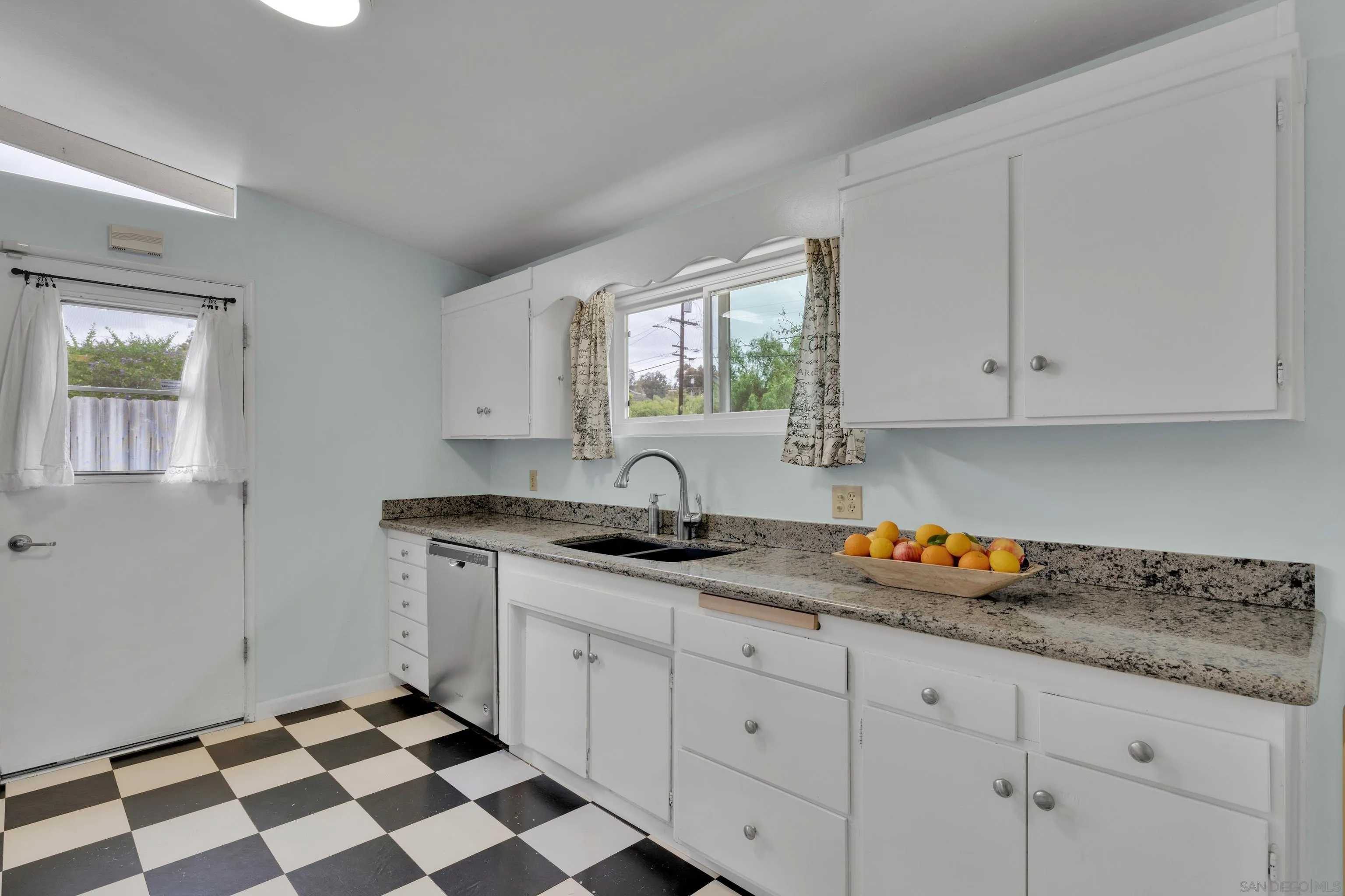 13834 Tobiasson Road Poway, CA 92064 - Photo 14 of 31 a kitchen with granite countertop white cabinets and appliances