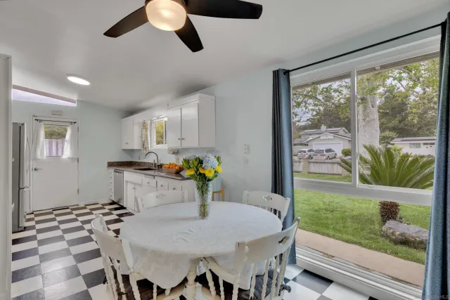 a kitchen with a table chairs and microwave