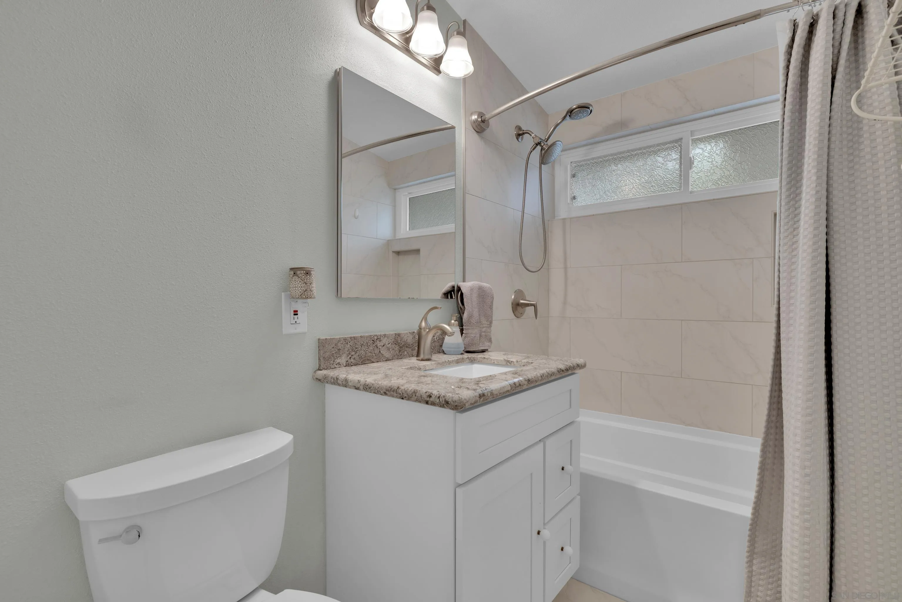 13834 Tobiasson Road Poway, CA 92064 - Photo 19 of 31 a bathroom with a granite countertop sink toilet and shower