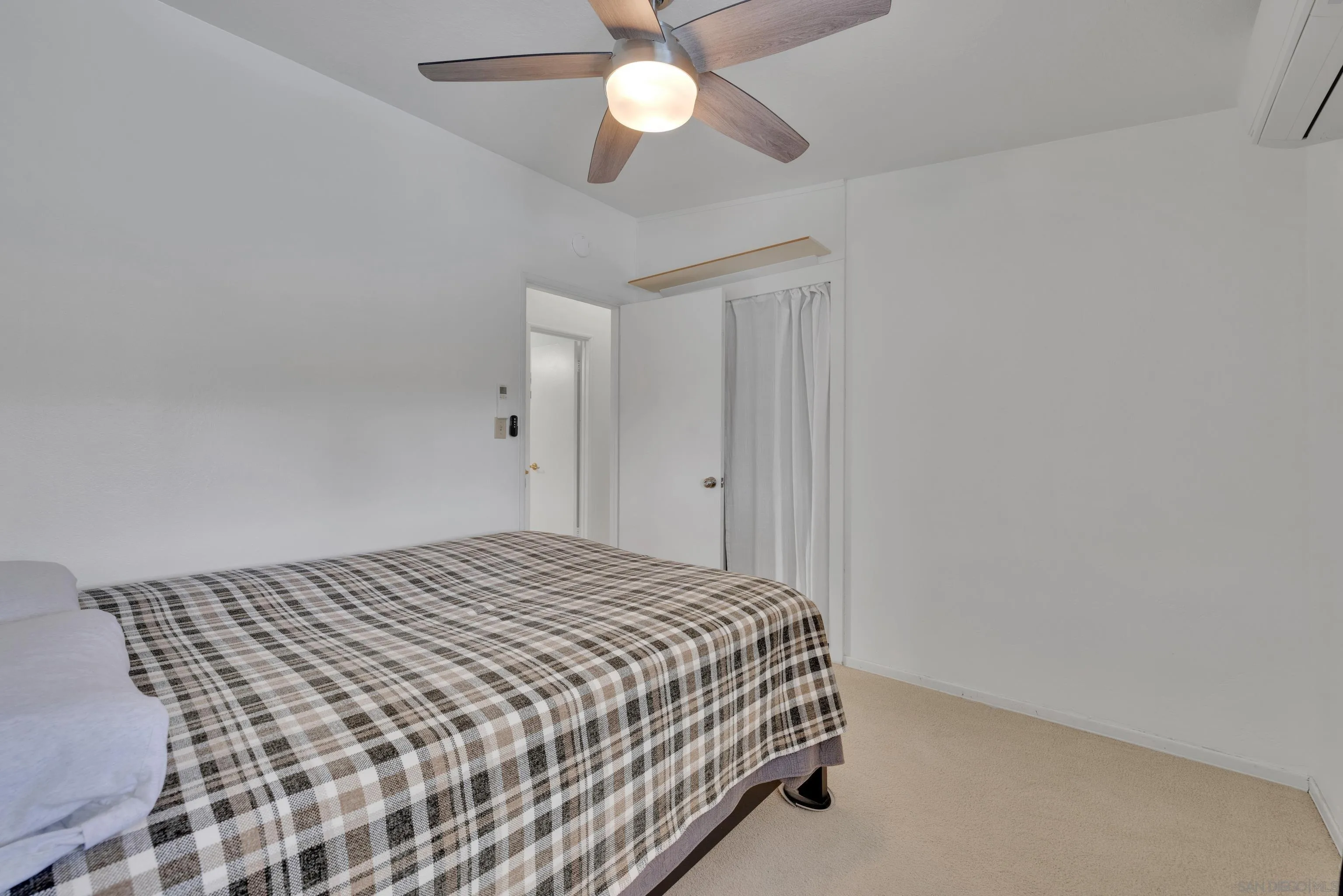 13834 Tobiasson Road Poway, CA 92064 - Photo 20 of 31 a bedroom with a bed and a chandelier