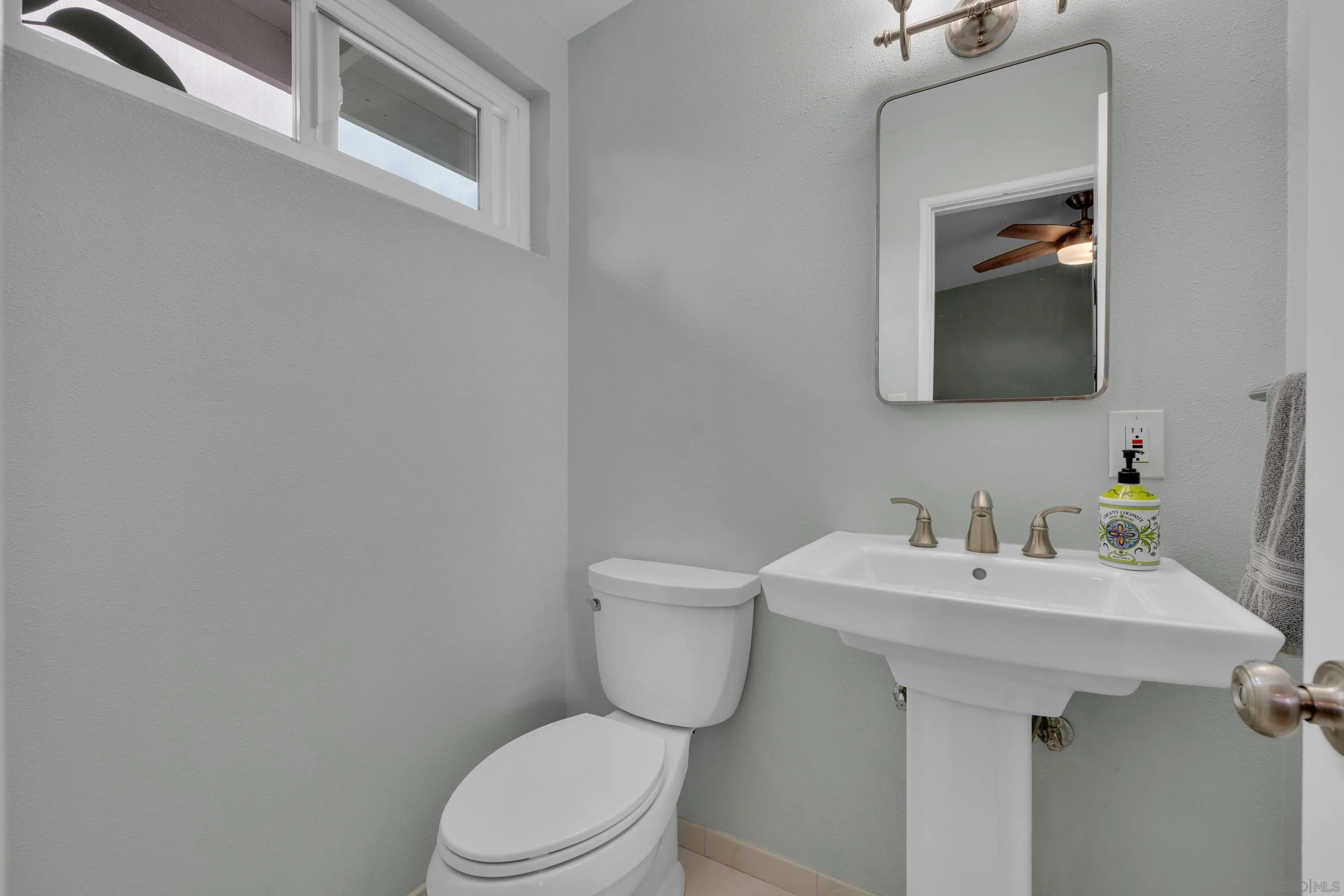 13834 Tobiasson Road Poway, CA 92064 - Photo 23 of 31 a bathroom with a sink toilet and mirror