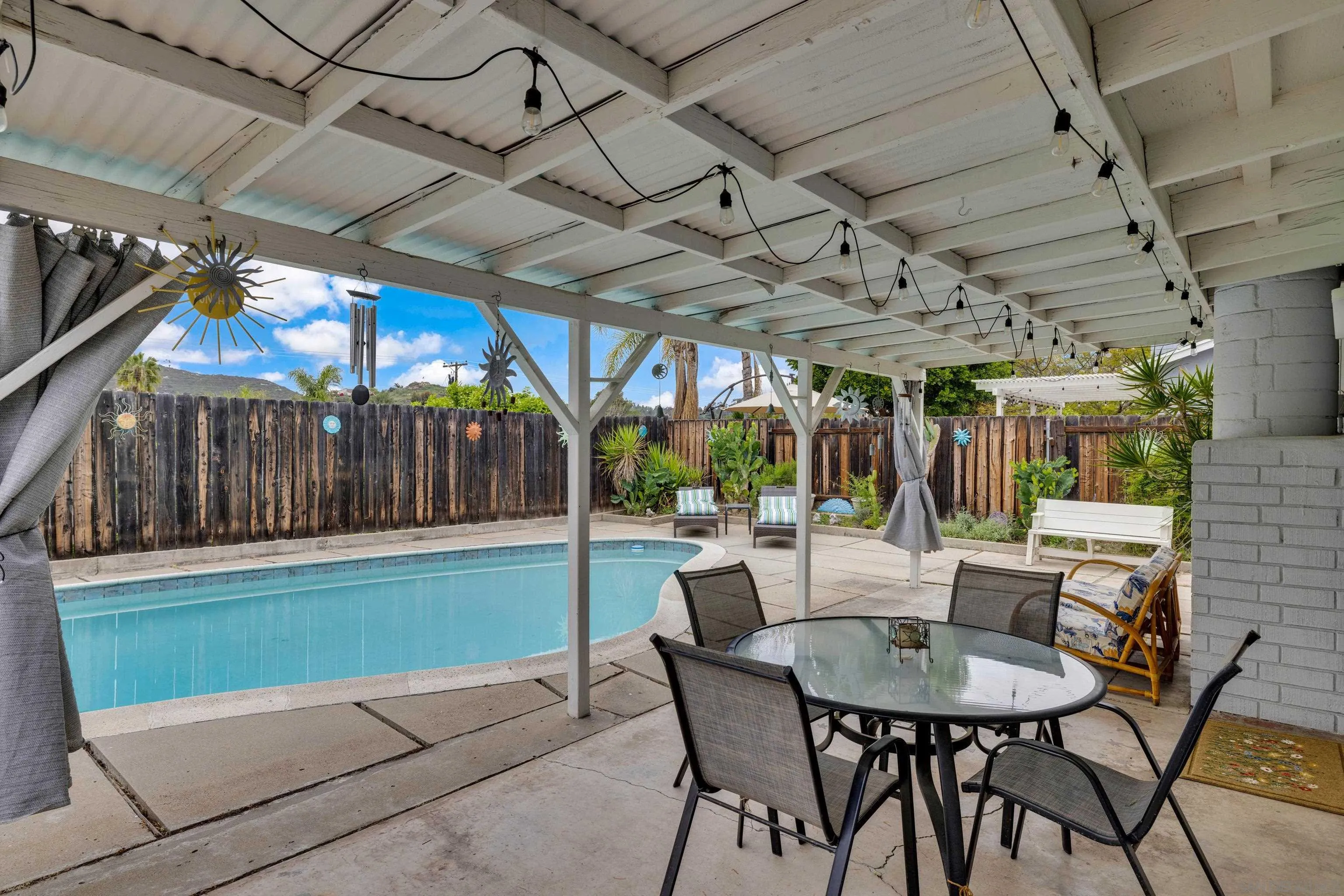 13834 Tobiasson Road Poway, CA 92064 - Photo 30 of 31 a view of a patio with a table and chairs and a barbeque