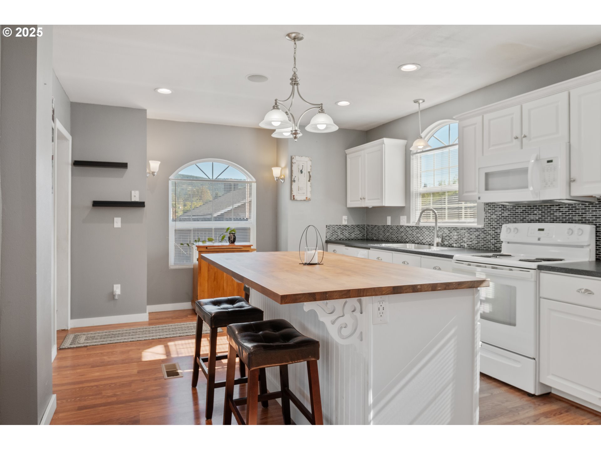1 Southwest D Street Castle Rock, WA 98611 - Photo 11 of 40 a kitchen with stainless steel appliances kitchen island a chandelier and cabinets