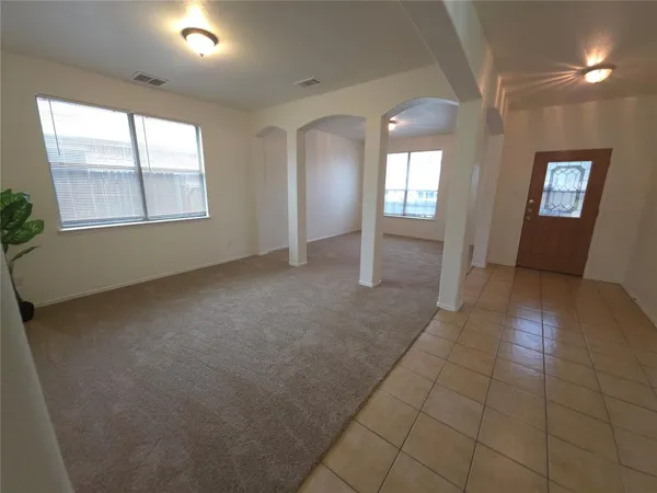 an empty room with windows and entrance