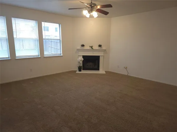 a view of empty room with window and fireplace