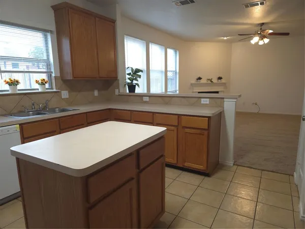 a kitchen with a sink cabinets and window