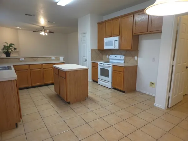 a kitchen with a cabinets and steel stove