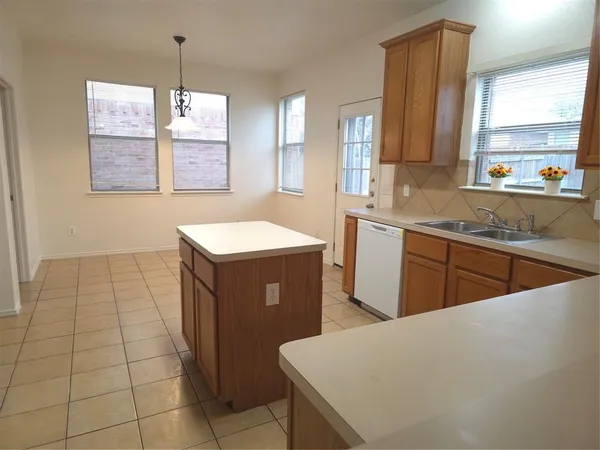 a kitchen with stainless steel appliances granite countertop a sink a stove a counter space and cabinets