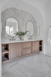 a bathroom with a double vanity sink toilet mirror and bathtub