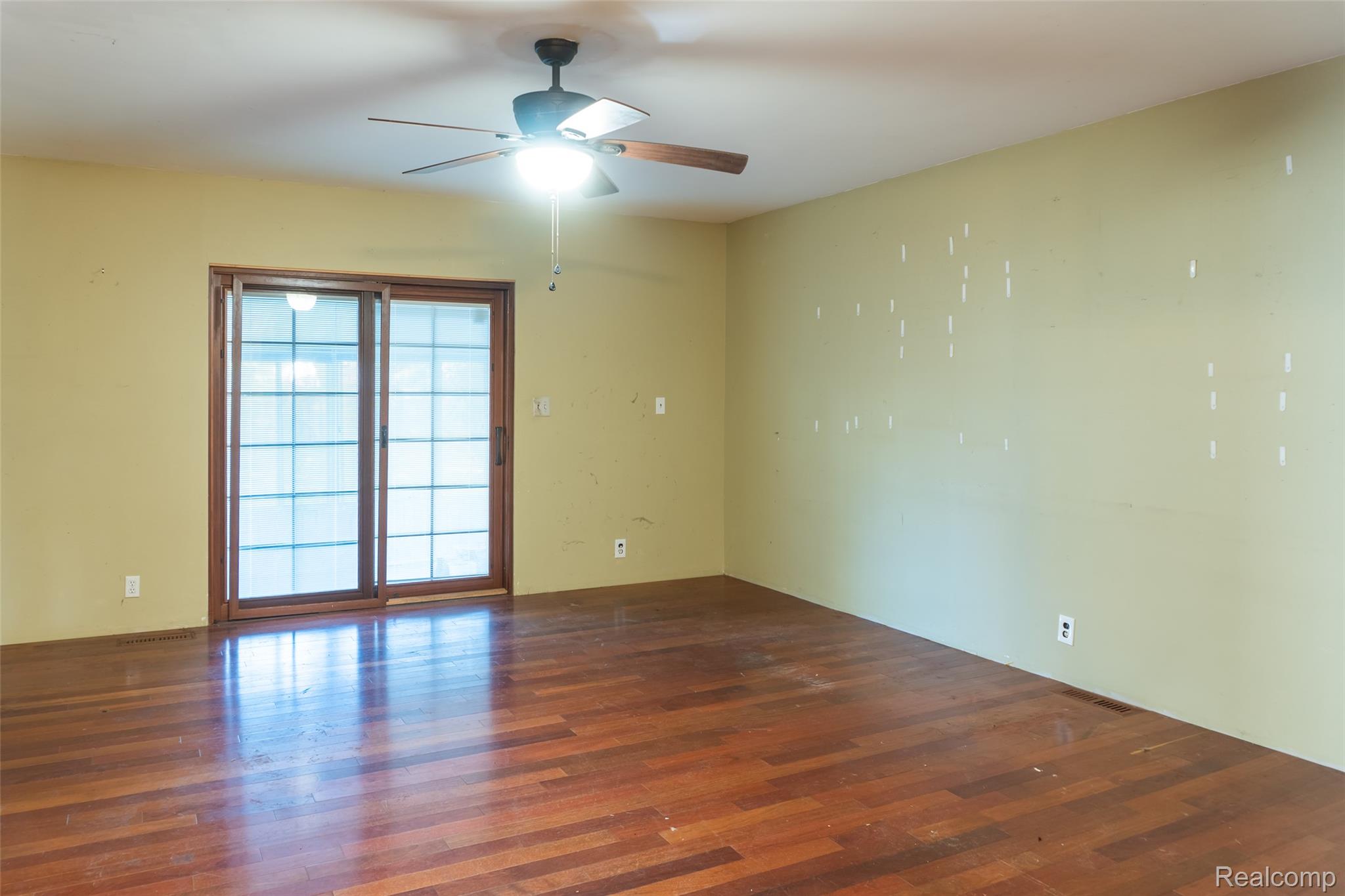 1846 North Gulley Road Dearborn, MI 48128 - Photo 11 of 32 Empty room featuring dark wood-style flooring and ceiling fan