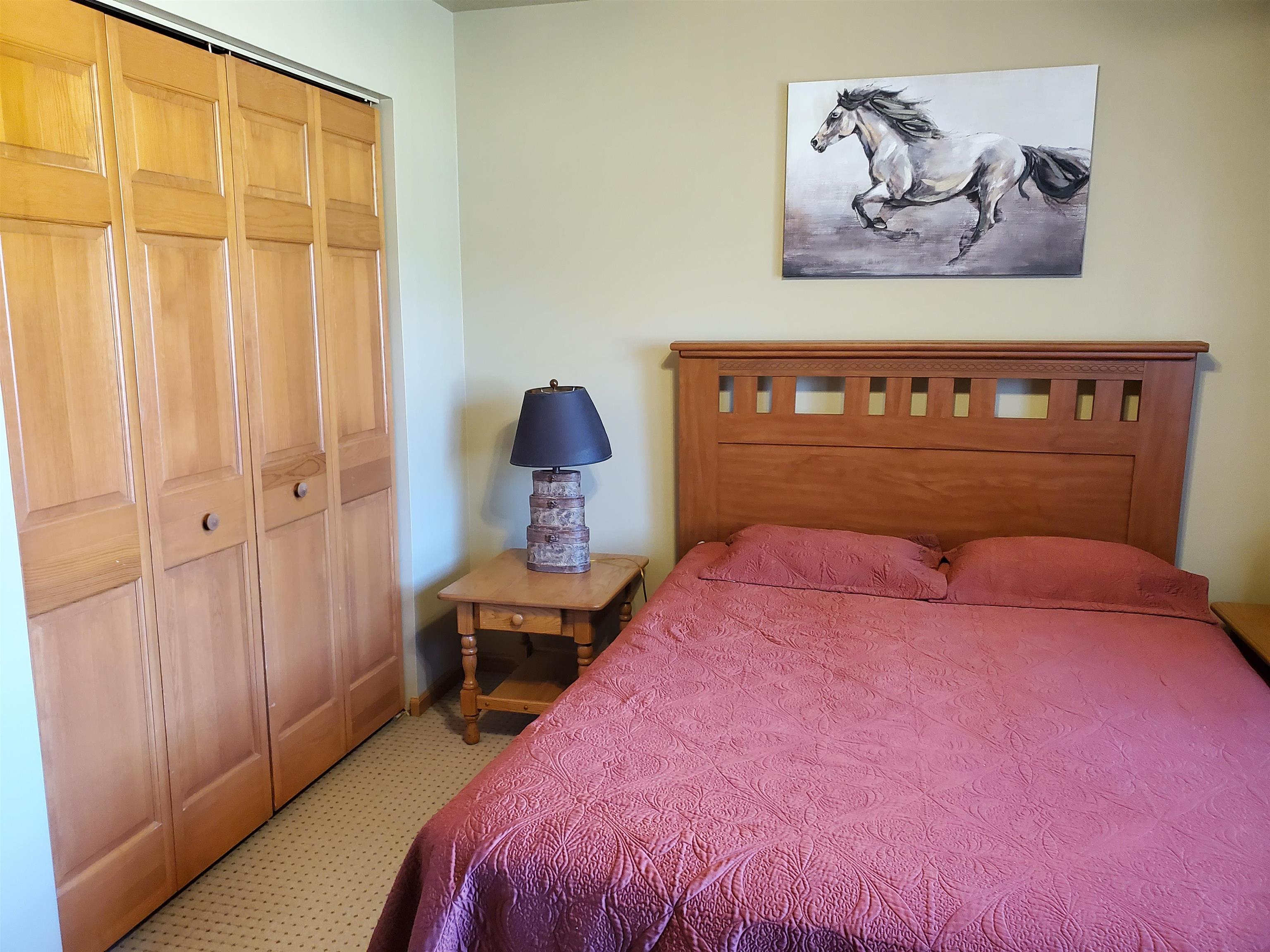 325 South Clark Street Utica, IL 61373 - Photo 20 of 28 a bedroom with a bed and wooden floor