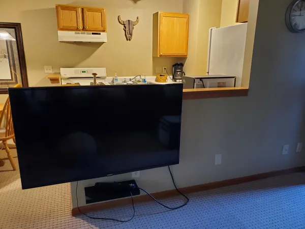 a living room with furniture a couch and chandelier
