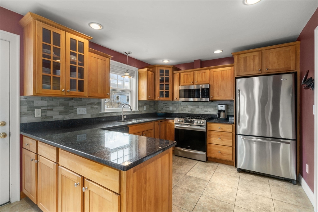 29 Governors Road Milton, MA 02186 - Photo 12 of 42 a kitchen with stainless steel appliances granite countertop a refrigerator a stove and a sink