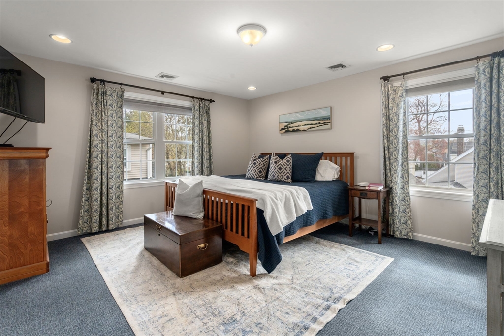 29 Governors Road Milton, MA 02186 - Photo 16 of 42 a bedroom with a bed and wooden floor