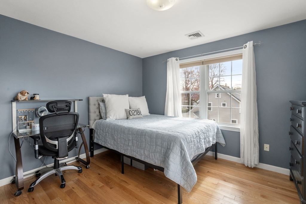 29 Governors Road Milton, MA 02186 - Photo 23 of 42 a bedroom with a bed a desk and chair with windows