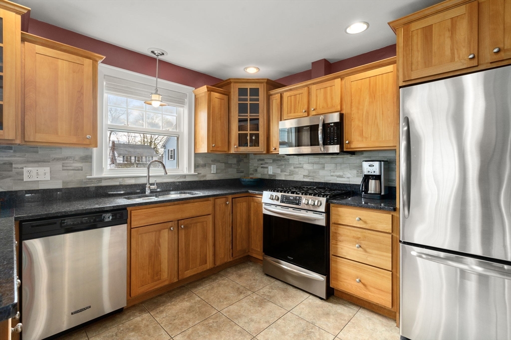 29 Governors Road Milton, MA 02186 - Photo 4 of 42 a kitchen with granite countertop stainless steel appliances a refrigerator sink and microwave