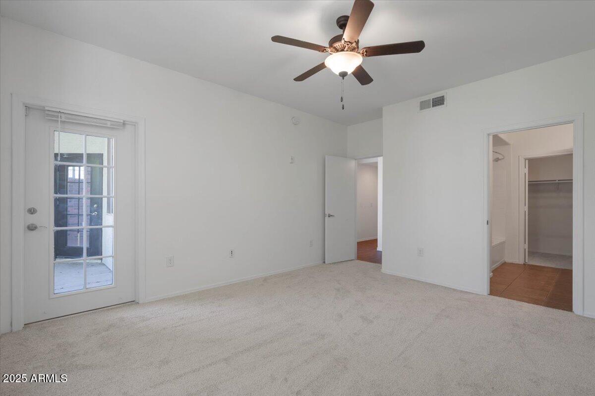 3302 North 7th Street, Unit 319 Phoenix, AZ 85014 - Photo 15 of 28 an empty room with closet and a chandelier fan