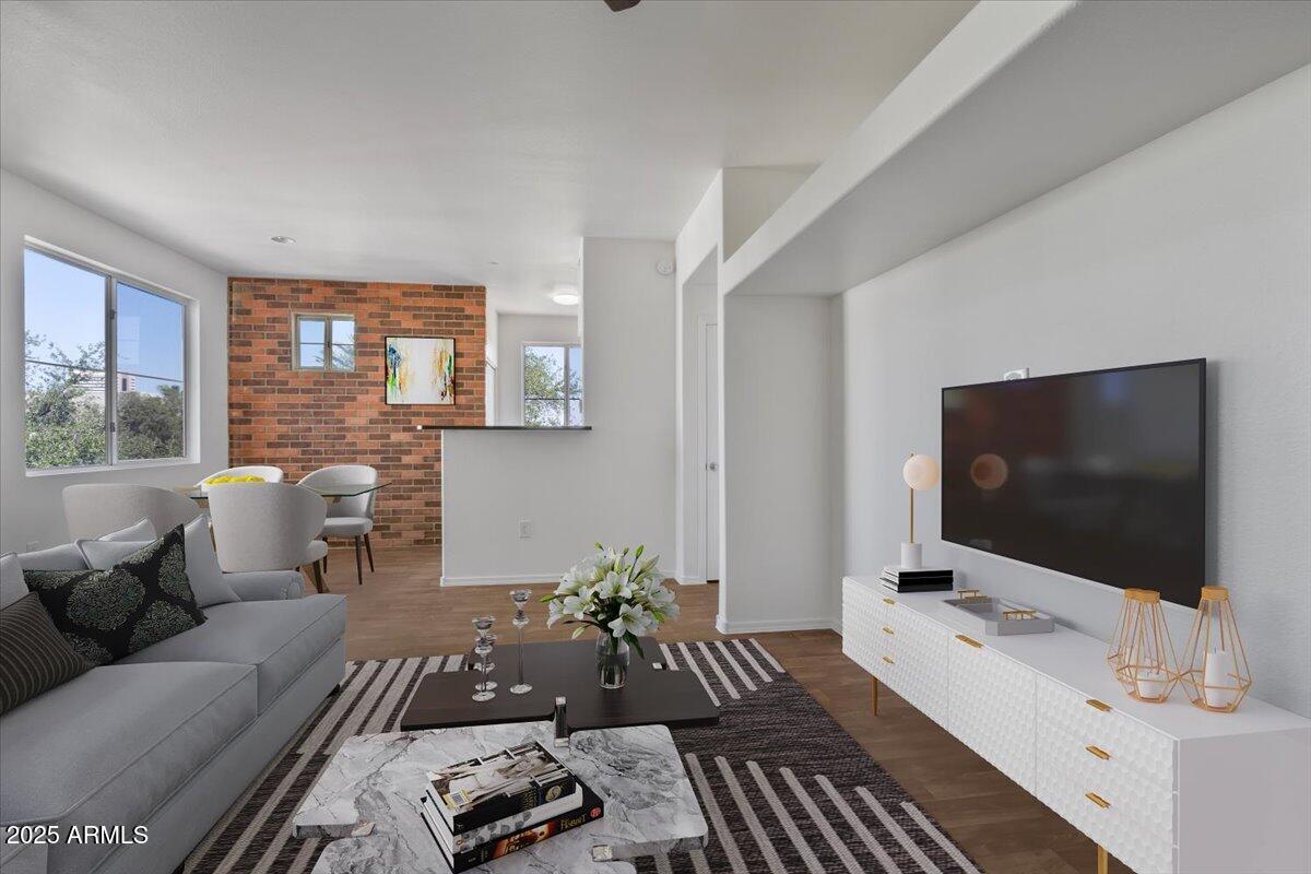 3302 North 7th Street, Unit 319 Phoenix, AZ 85014 - Photo 3 of 28 a living room with furniture and a flat screen tv