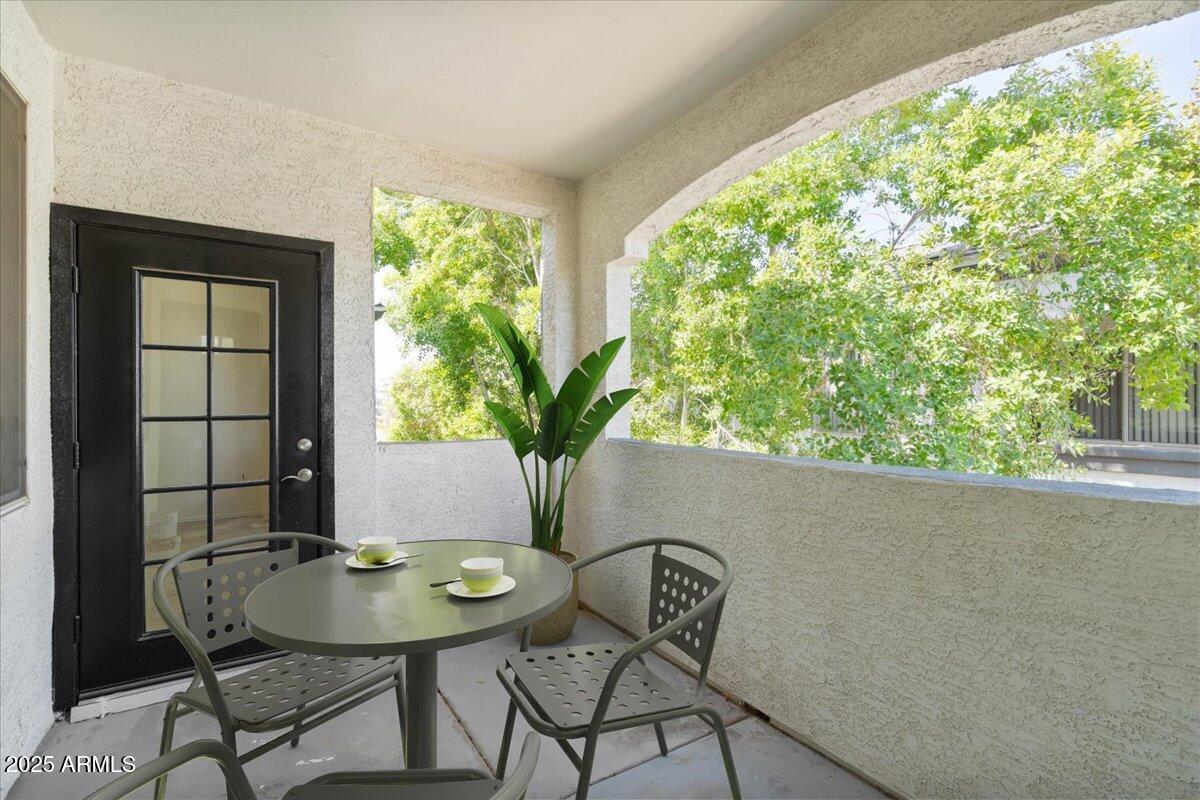3302 North 7th Street, Unit 319 Phoenix, AZ 85014 - Photo 7 of 28 a view of a balcony dining table and chairs