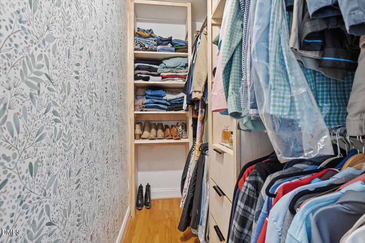 1007 Castalia Drive Cary, NC 27513 - Photo 11 of 30 a view of walk in closet with clothes and shoes