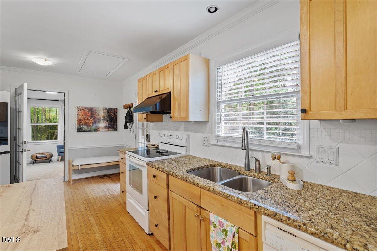 1007 Castalia Drive Cary, NC 27513 - Photo 17 of 30 a kitchen with a sink a counter top space cabinets and stainless steel appliances
