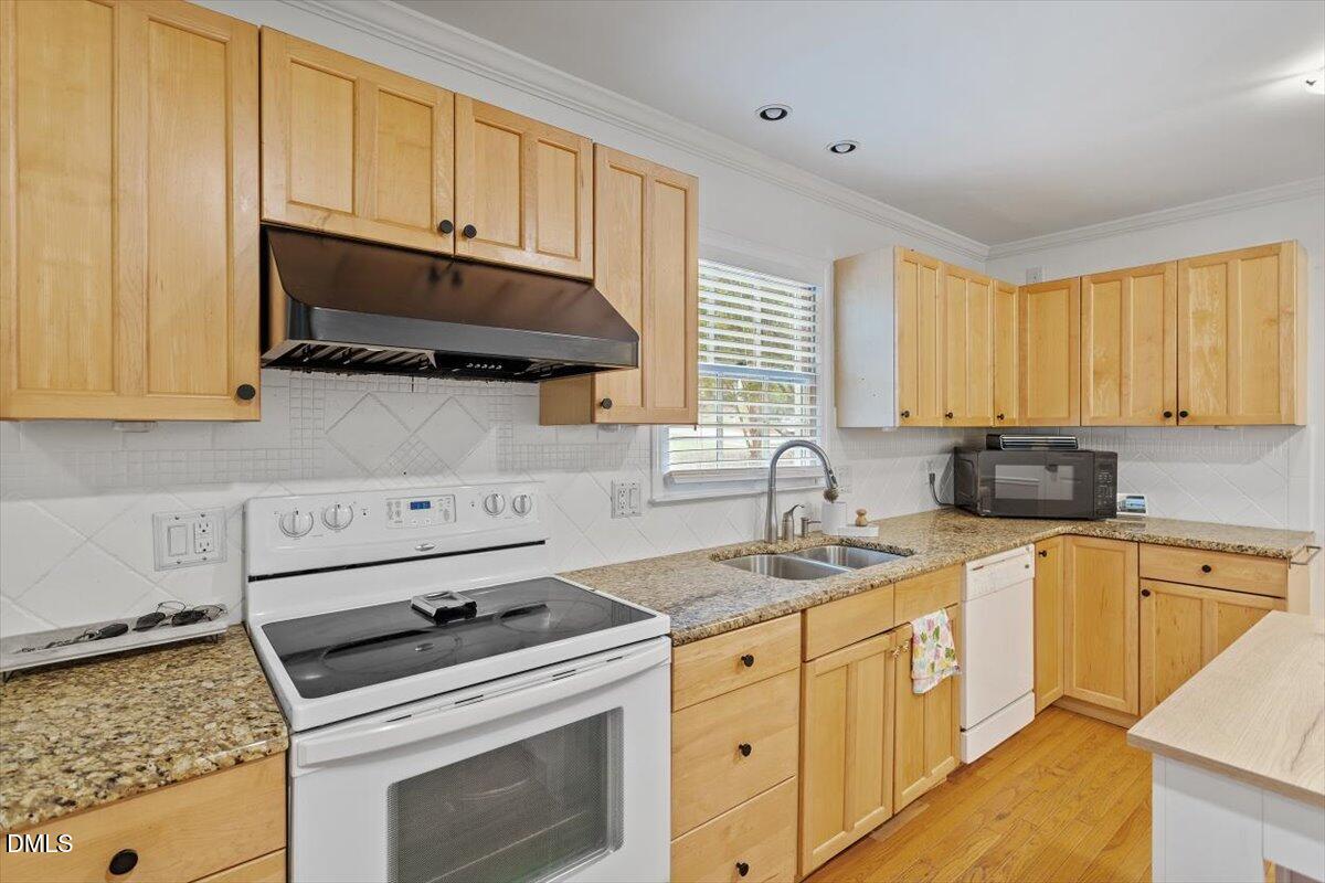 1007 Castalia Drive Cary, NC 27513 - Photo 19 of 30 a kitchen with granite countertop a stove sink and cabinets