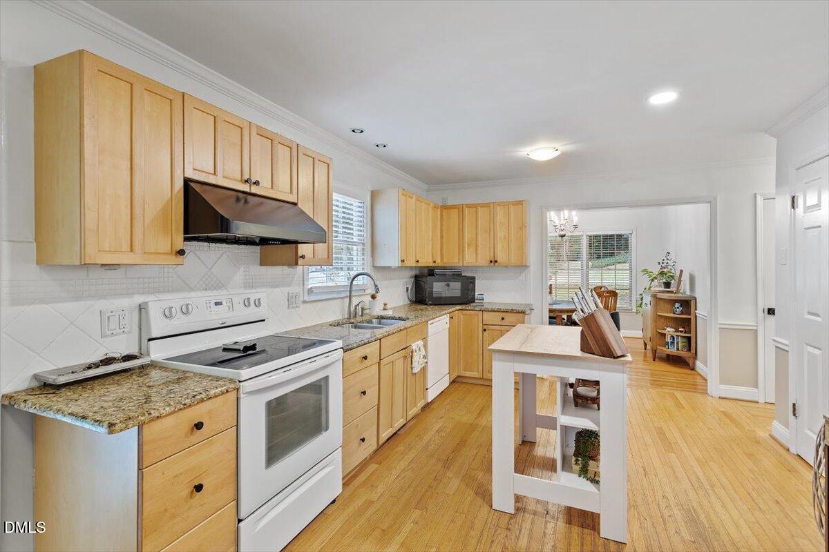 1007 Castalia Drive Cary, NC 27513 - Photo 20 of 30 a kitchen with stainless steel appliances granite countertop a stove a sink and a microwave