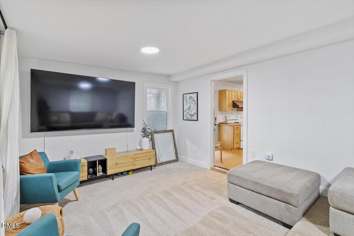 1007 Castalia Drive Cary, NC 27513 - Photo 22 of 30 a living room with furniture and a flat screen tv