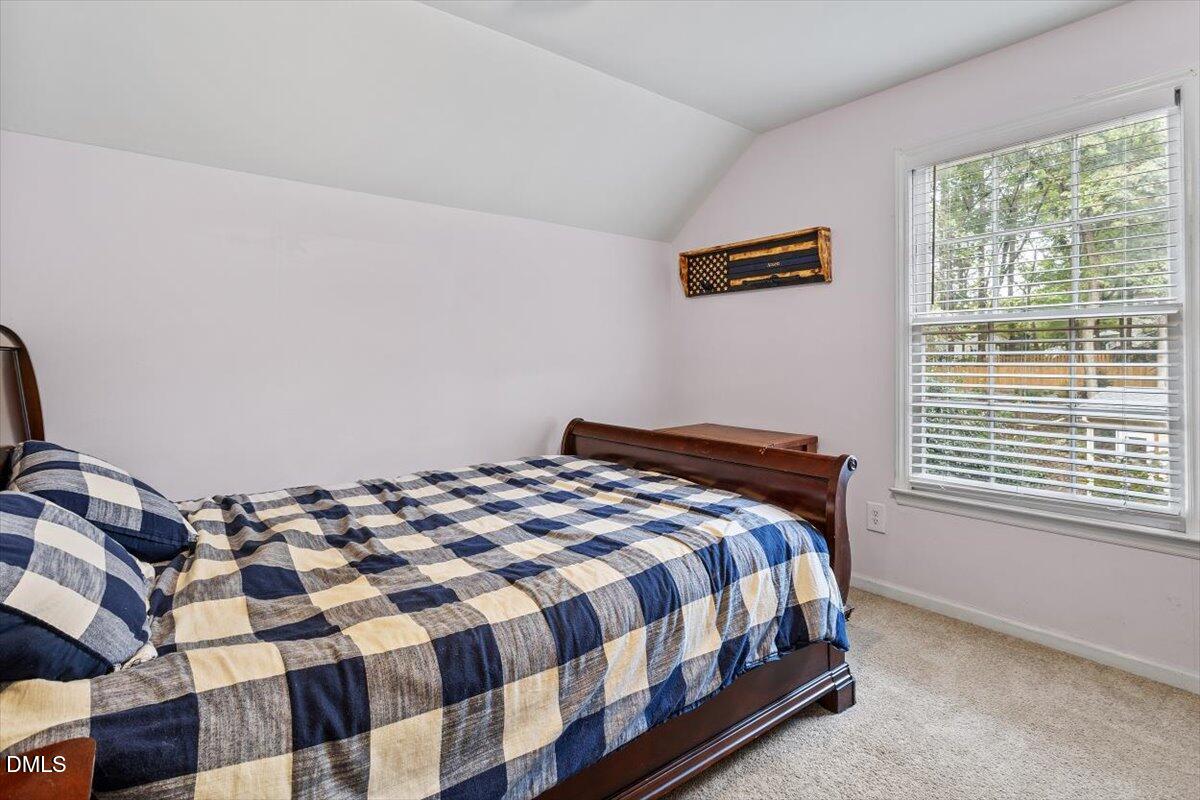 1007 Castalia Drive Cary, NC 27513 - Photo 23 of 30 a bedroom with a bed and a window