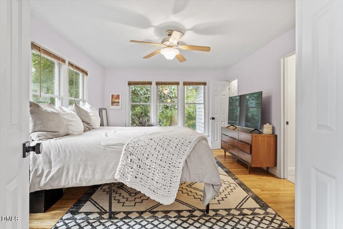 1007 Castalia Drive Cary, NC 27513 - Photo 8 of 30 a bedroom with a bed and a chandelier