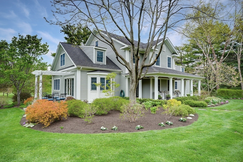 191 Claybrook Road Dover, MA 02030 - Photo 1 of 34 a front view of a house with a garden
