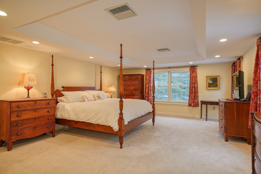 191 Claybrook Road Dover, MA 02030 - Photo 16 of 34 a large bed sitting in a room next to a window