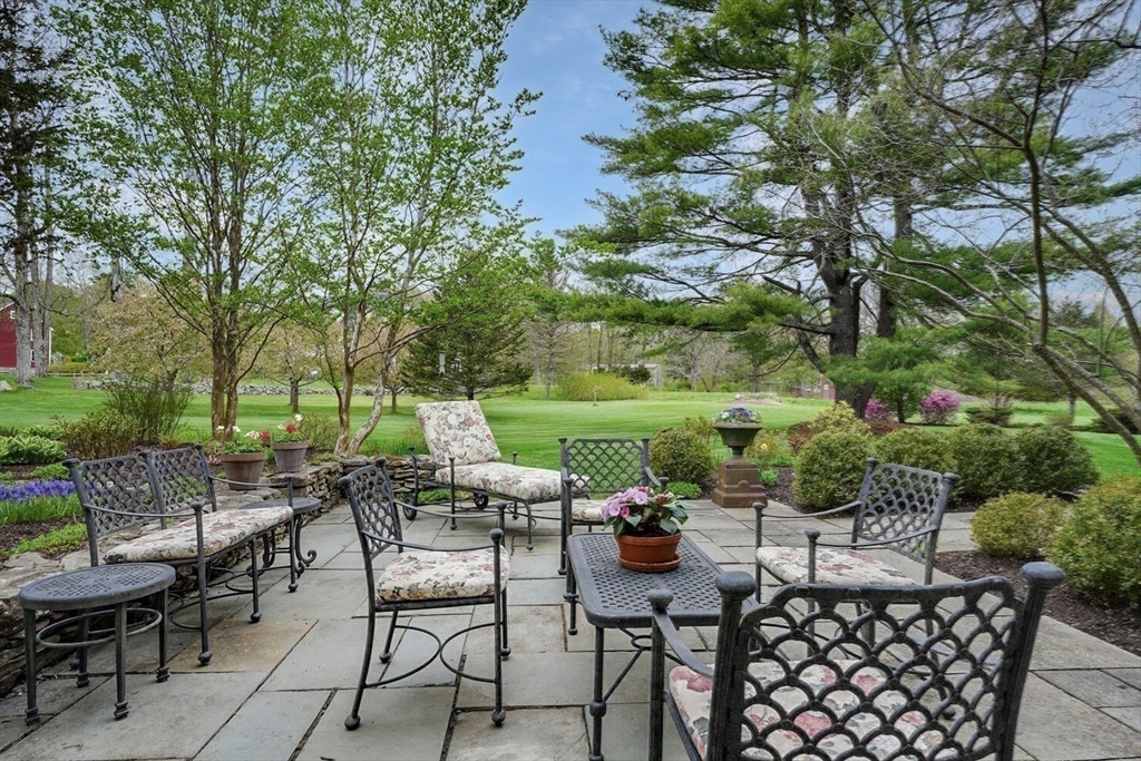 191 Claybrook Road Dover, MA 02030 - Photo 27 of 34 a view of a patio with a table and chairs
