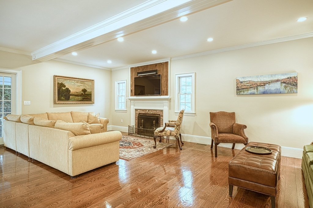 191 Claybrook Road Dover, MA 02030 - Photo 9 of 34 a living room with furniture a fireplace and a flat screen tv