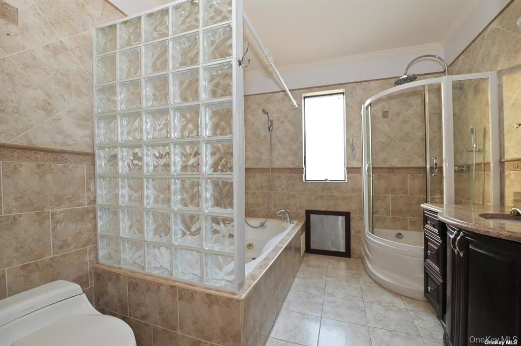 108-35 66th Road Queens, NY 11375 - Photo 15 of 19 a bathroom with a bathtub and a shower